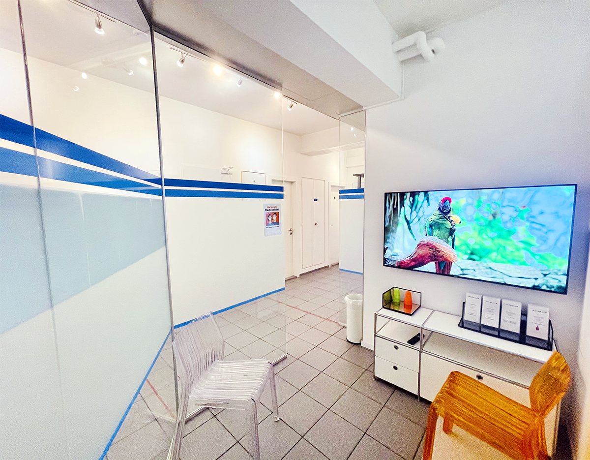 Wartezimmer der ACC Zahnklinik Basel, Überblick mit Sitzbereich und Dekoration